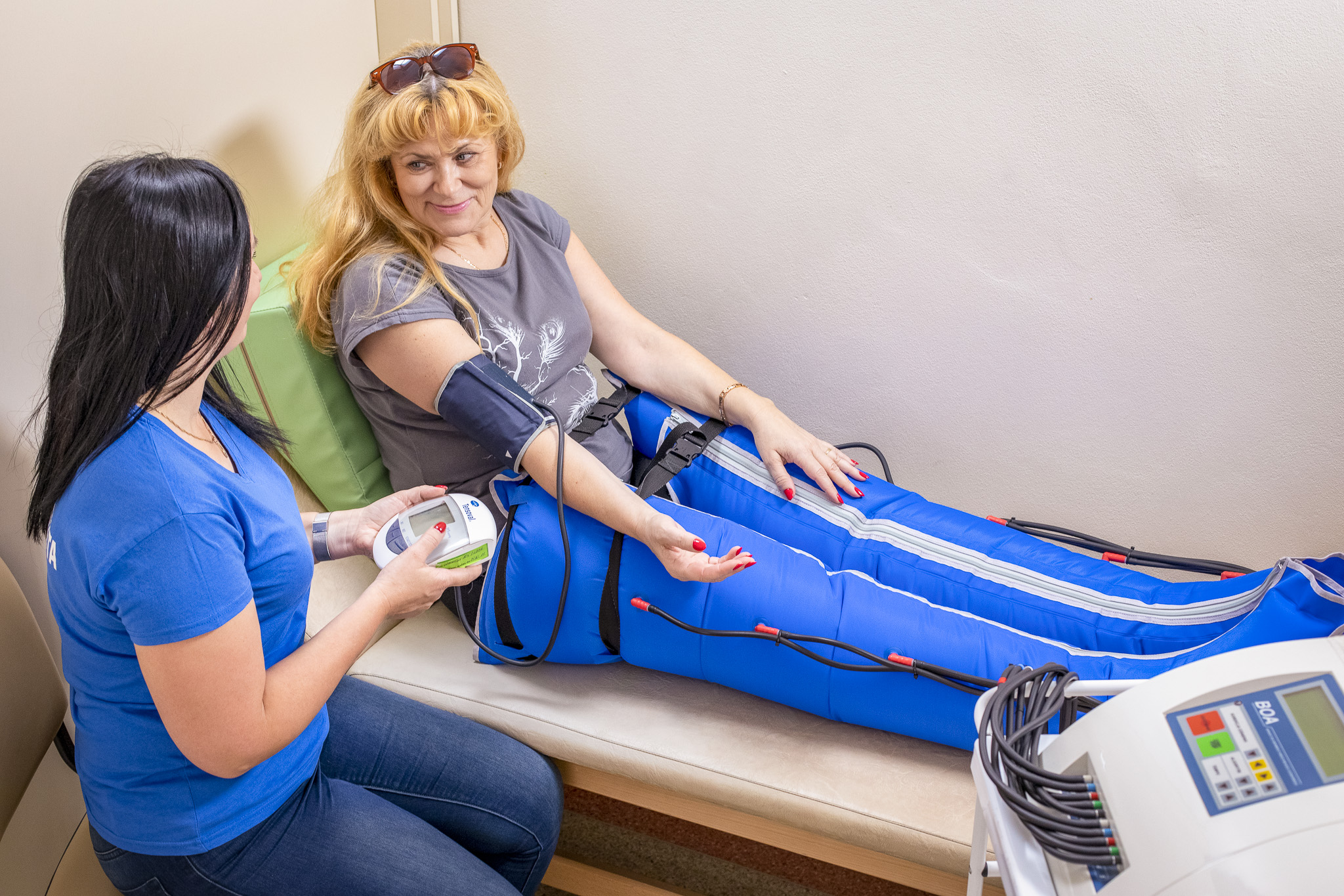 Doctor and female patient during a compression lymphatic massage.